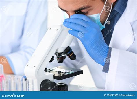 Male Scientist Working With Microscope In Laboratory Closeup Stock