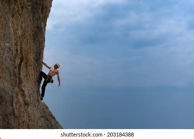 Silhouette Man Climbing On Rock Mountain Stock Photo 203184388