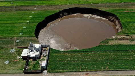 Massive sinkhole swallowing up farmland in Central Mexico's Puebla state, growing by the day ...