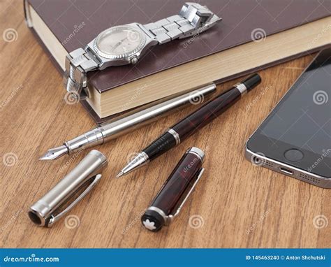 Notepad Pen And Watches On The Wood Desk Stock Photo Image Of Gold