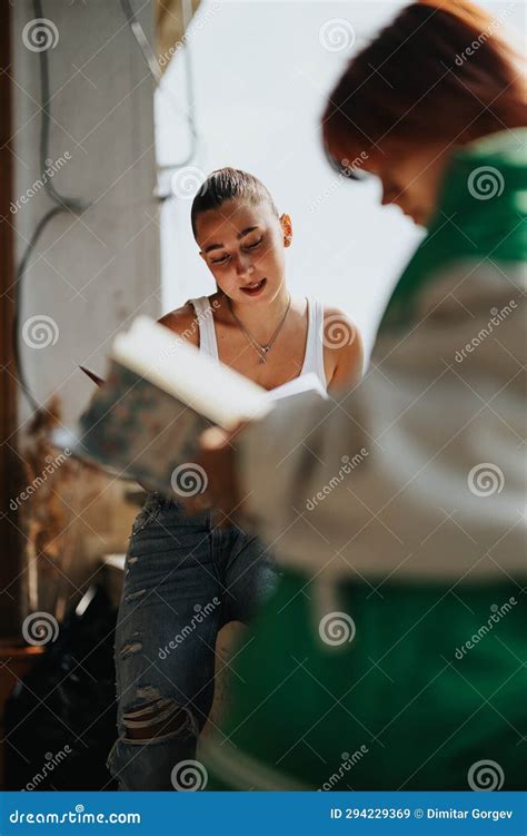 Two High School Students Studying Outdoors Collaborating On A School