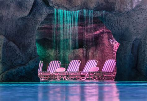 Inviting Cozy Comfortable Grotto In Swimming Pool At Night Time Stock