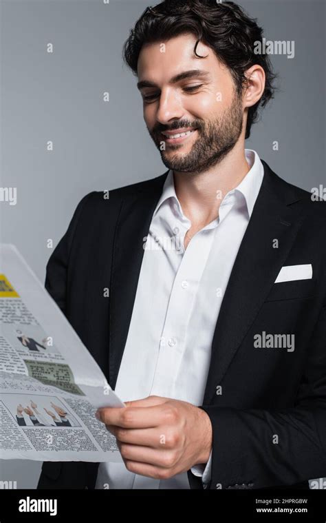 Happy Brunette Businessman In Black Blazer Reading Newspaper Isolated