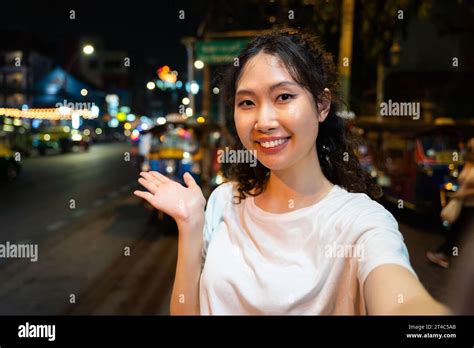 Portrait Of Happy Relaxing Asian Solo Hipster Traveller Taking A Selfie