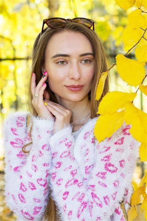 Young Woman With Autumn Leaves And Fall Yellow Maple Garden Background