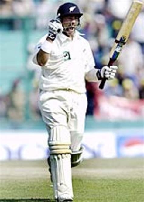 Craig McMillan punches the air after reaching his century ...