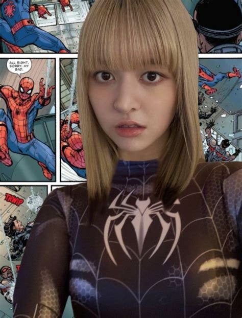 A Woman With Blonde Hair And Spider Man Costume In Front Of An Image