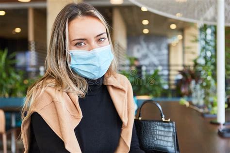 Woman With Face Mask Sitting In A Cafe Or Restaurant Stock Image