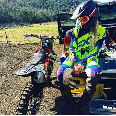 A Woman Sitting On The Back Of A Motorcycle Next To A Dirt Bike