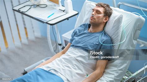 In The Hospital Sick Male Patient Sleeps On The Bed Hes Wearing Nasal