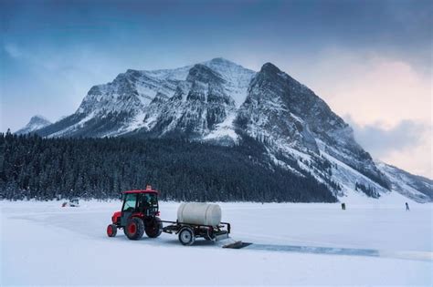 Tractor arando nieve en un lago congelado preparándose para una pista