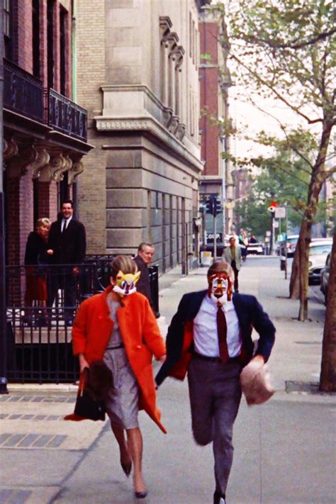 Two People Walking Down The Street With Clown Faces On Their Face And