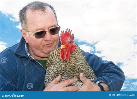 Man Holding A Rooster In His Arms Stock Photo Image Of Fauna