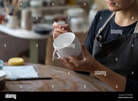 Craftswoman Makes Sketch Of Future Pattern On White Mug To Decorate