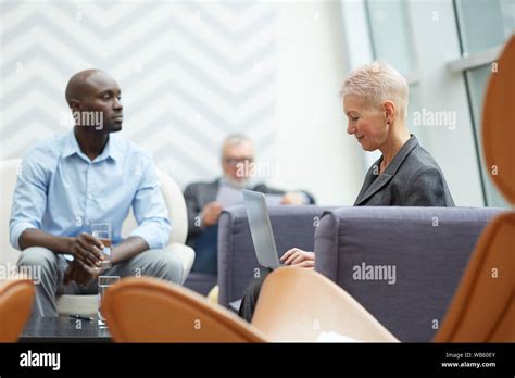 Side View Portrait Of Successful Senior Businesswoman Using Laptop