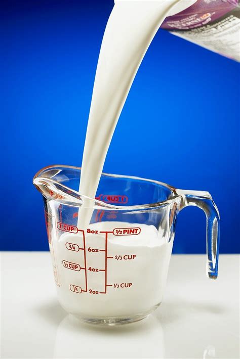 Pouring Milk Into A Glass Measuring  License Image 647707 Image Professionals