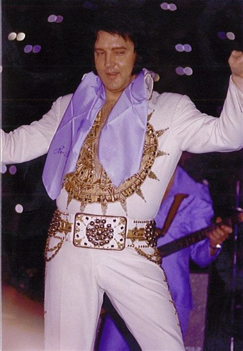 Elvis Presley Performing On Stage With His Hands In The Air