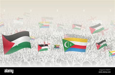 Palestine And Comoros Flags In A Crowd Of Cheering People Crowd Of