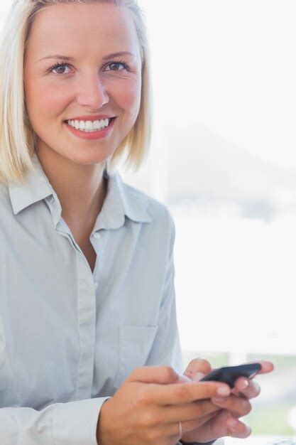 Premium Photo Blonde Businesswoman Texting And Smiling