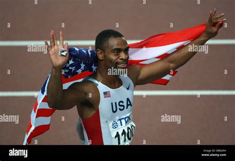 US American Sprinter Tyson Gay Holds An American Flag While Celebrating His Victory In The Men S
