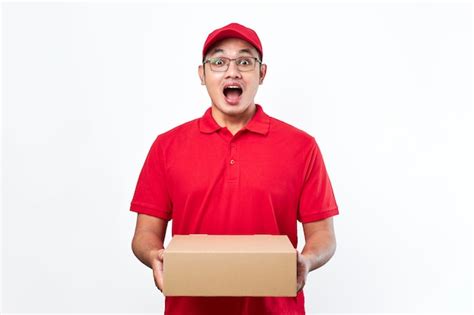 Premium Photo Cheerful Asian Man In Red Cap And Tshirt Holding Parcel