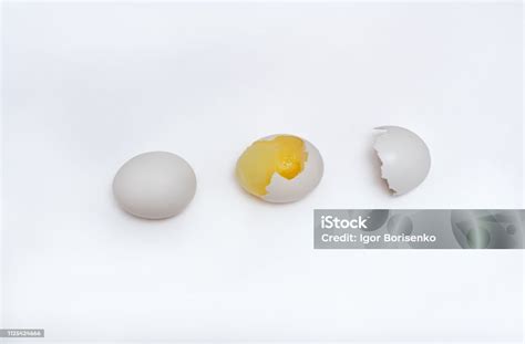 Concept Of Whole Egg Yolk Hidden Under The Shell And Broken Egg Without Yolk On An Isolated