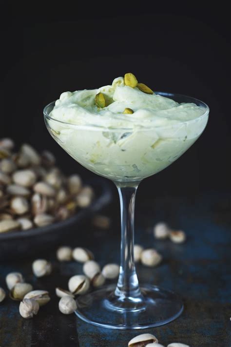 Low Carb Pistachio Mousse Recipe Served In A Champagne Glass With Pistachios In The Background