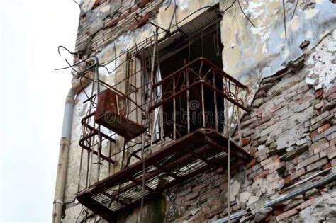 Old Rusty Metal Balcony On A Deteriorating Brick Building Stock Image