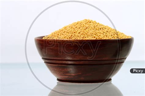 Image Of Yellow Mustard Seeds In A Bowl Isolated On White Background