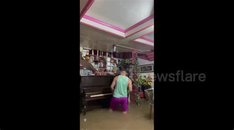 Filipino Resident Plays Piano While Standing In Knee Deep Floodwater