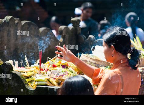 Balinese Woman Praying With Incense At Pura Tirta Empul Hindu Temple Bali Indonesia Southeast