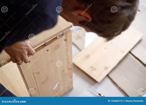 Man Assembling Wooden Furniture At Home Close Up Image Stock Image