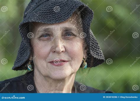 Portrait Of A Happy Elderly Woman 65 70 Years Old In A Straw Hat On The Background Of Nature