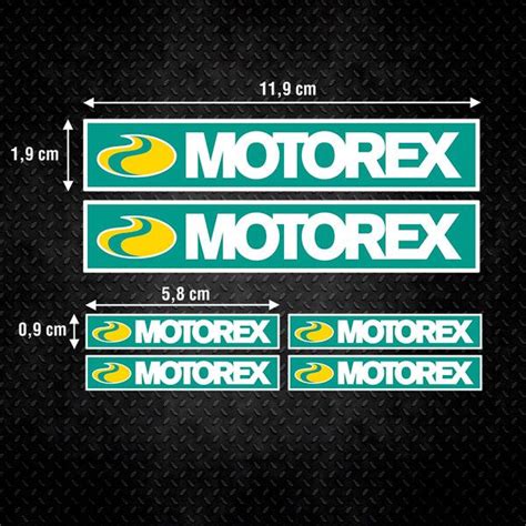 Two Green And Yellow Motorex Stickers On A Black Background