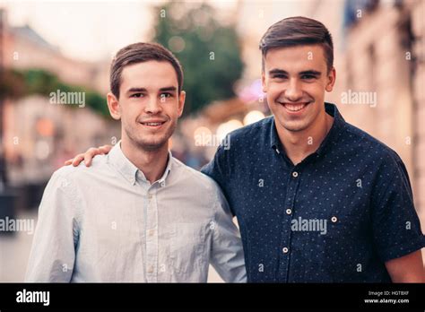 Two Smiling Friends Standing Together On A City Street Stock Photo Alamy