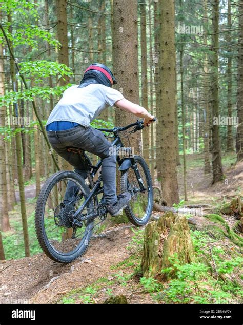 Mountainbike Riders Doing A Courageous Downhill On Forest Trails Stock