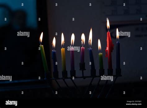 Multi Colored Wax Hanukkah Candles Burn In A Menorah During