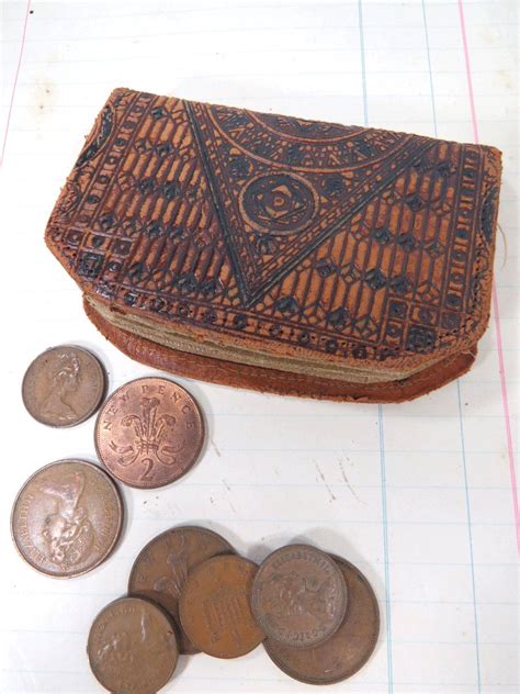 Some Coins And A Wallet On A Table