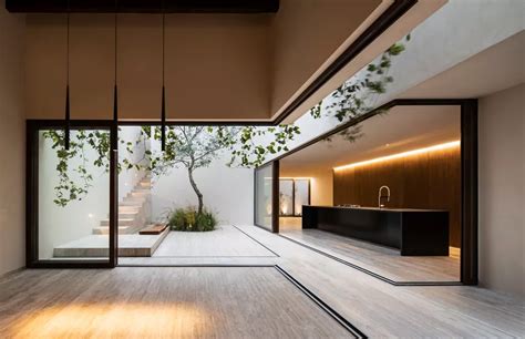 The Interior Of A Modern House With Wood Floors And Glass Doors Leading