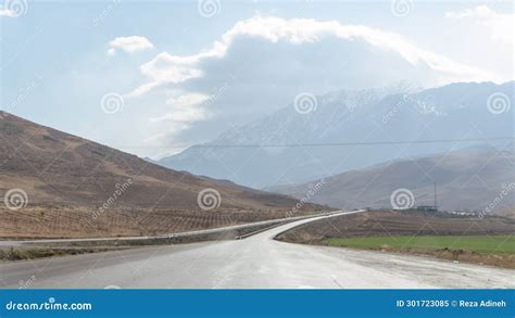 Asphalt Road Leading To The Mountains On A Cloudy Day Stock Image