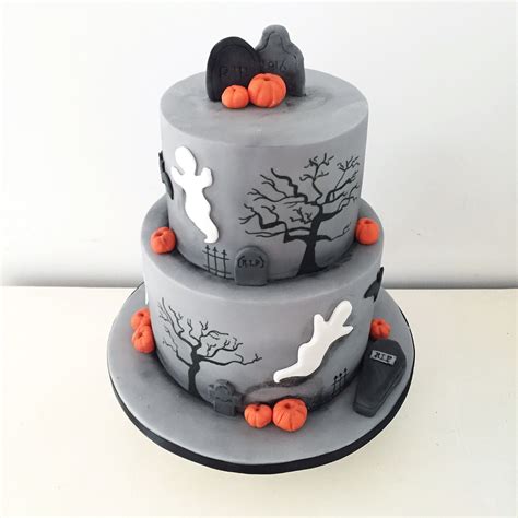 Two Tier Halloween Cake With Pumpkins Bats And Ghosts By Blossom And Crumb Halloween Cakes