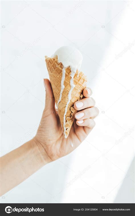 Cropped View Female Hand Melting Ice Cream Cone Stock Photo