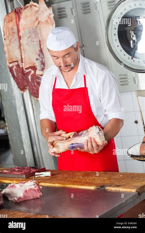 Butcher Holding Meat In Butchery Stock Photo Alamy