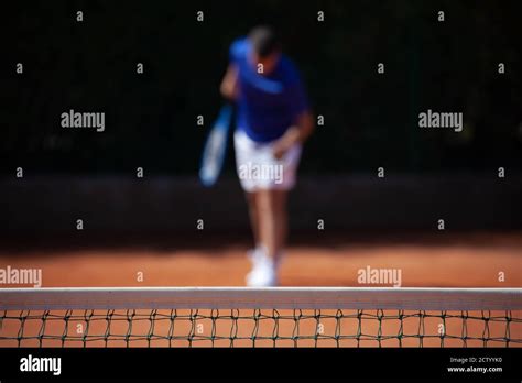 Tennis Player Preparing For The First Serve Shooting On A Clay
