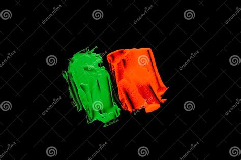 Green Orange Color Paint Splotches On Black Background Stock Image