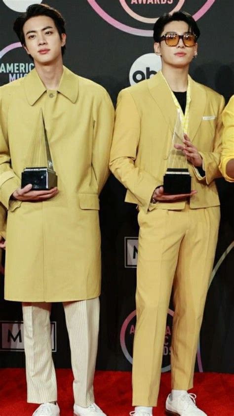 Two Men In Yellow Suits And White Shoes Holding Their Awards For Best