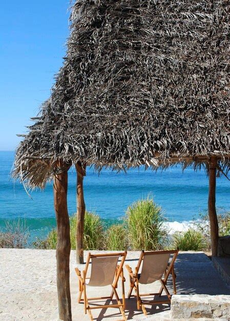 Premium Photo Deck Chairs On Beach Against Clear Sky