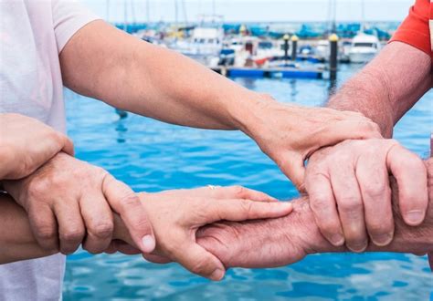 Premium Photo Midsection Of Senior Friends Holding Hands While