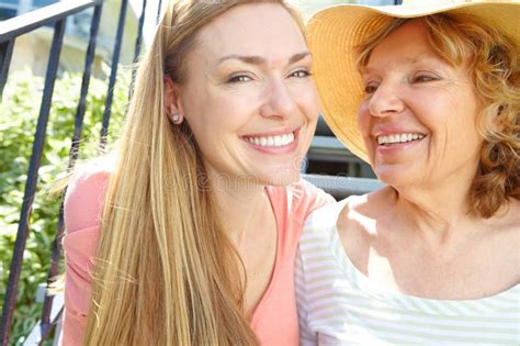Spending Time With Mom In The Summer Sun A Beautiful Mature Woman Smiling Widely While Spedning