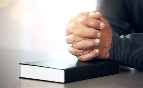 Senior Person Praying With Bible Book Expressing Faith Photo Background